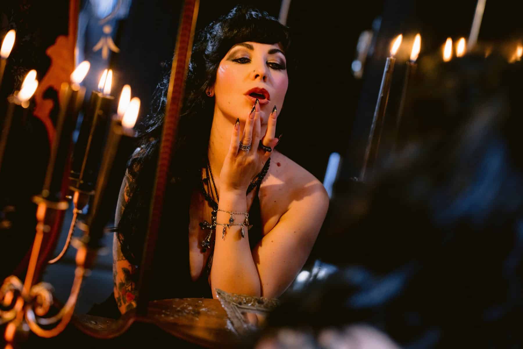 Witchy themed boudoir session with vintage vanity set, black candles, stiletto nails and a handmade black lingerie set in philly suburbs
