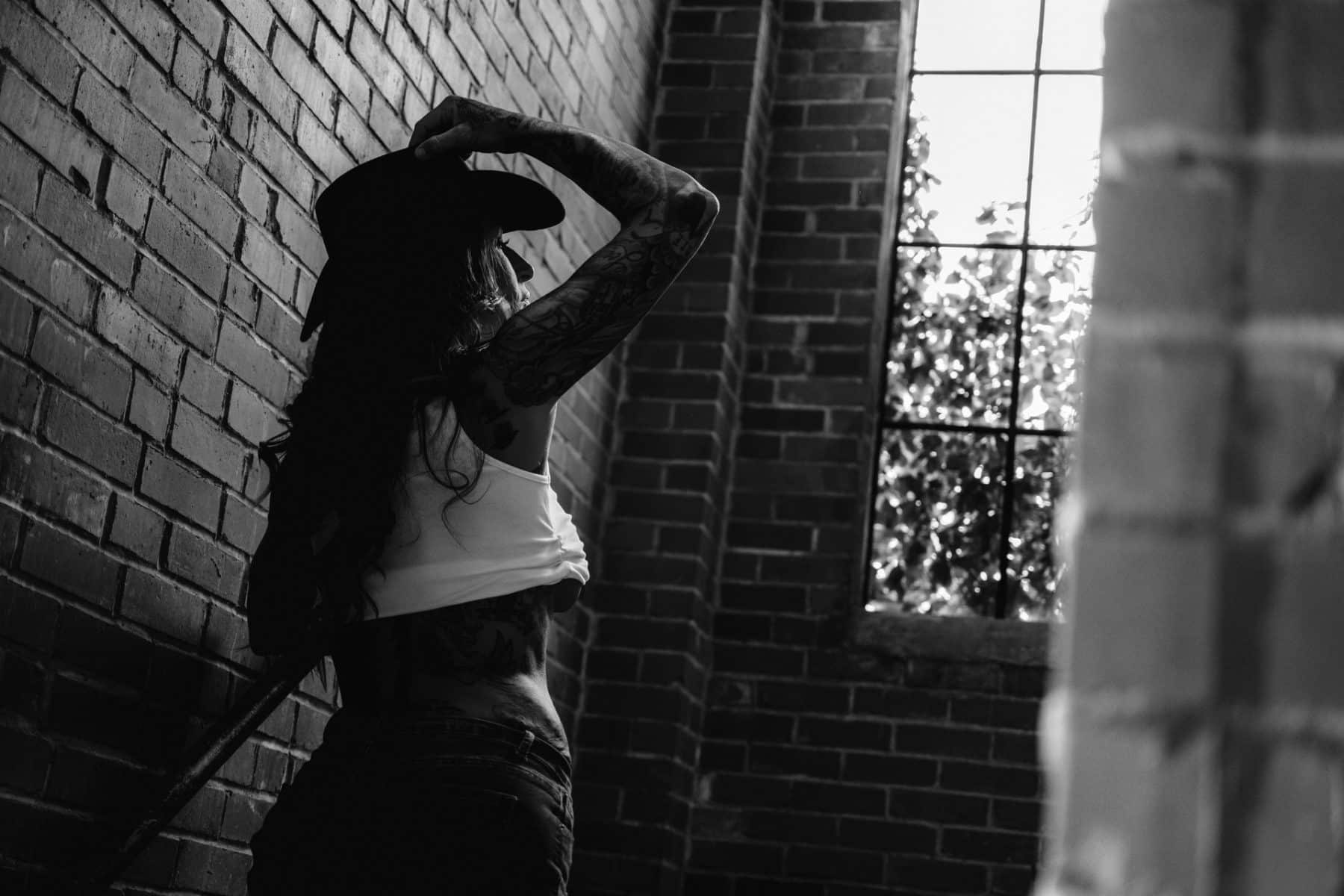 Black and white breakup boudoir session with cowboy hat